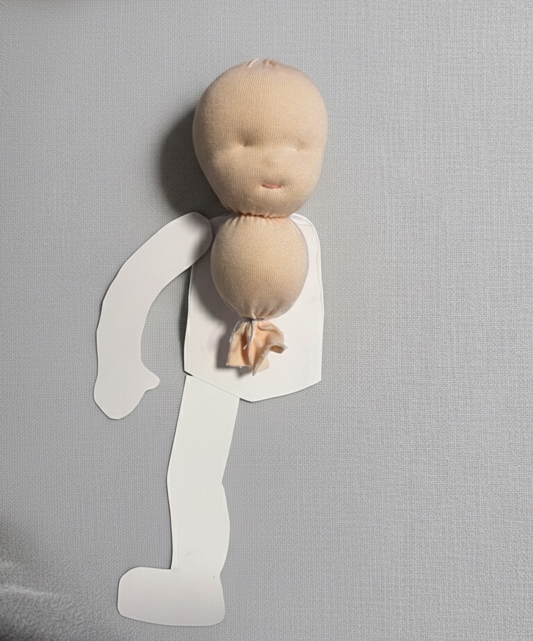 Person hand-stitching a soft doll